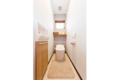トイレは窓を広く確保し、一部の壁を水色の壁紙を用い爽やかな空間に