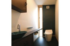 トイレは和室とは対照的に、スタイリッシュで深みのあるテイストに。縦長のスリット窓がデザイン性を高めている