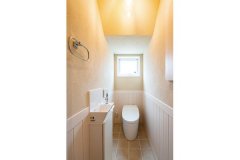 トイレの腰壁にも自然素材をふんだんに用いて。無垢材と珪藻土の空間は、湿気や臭いがこもらず快適さを保ちます。